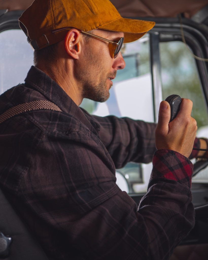 Truck Driver Talking On Radio.